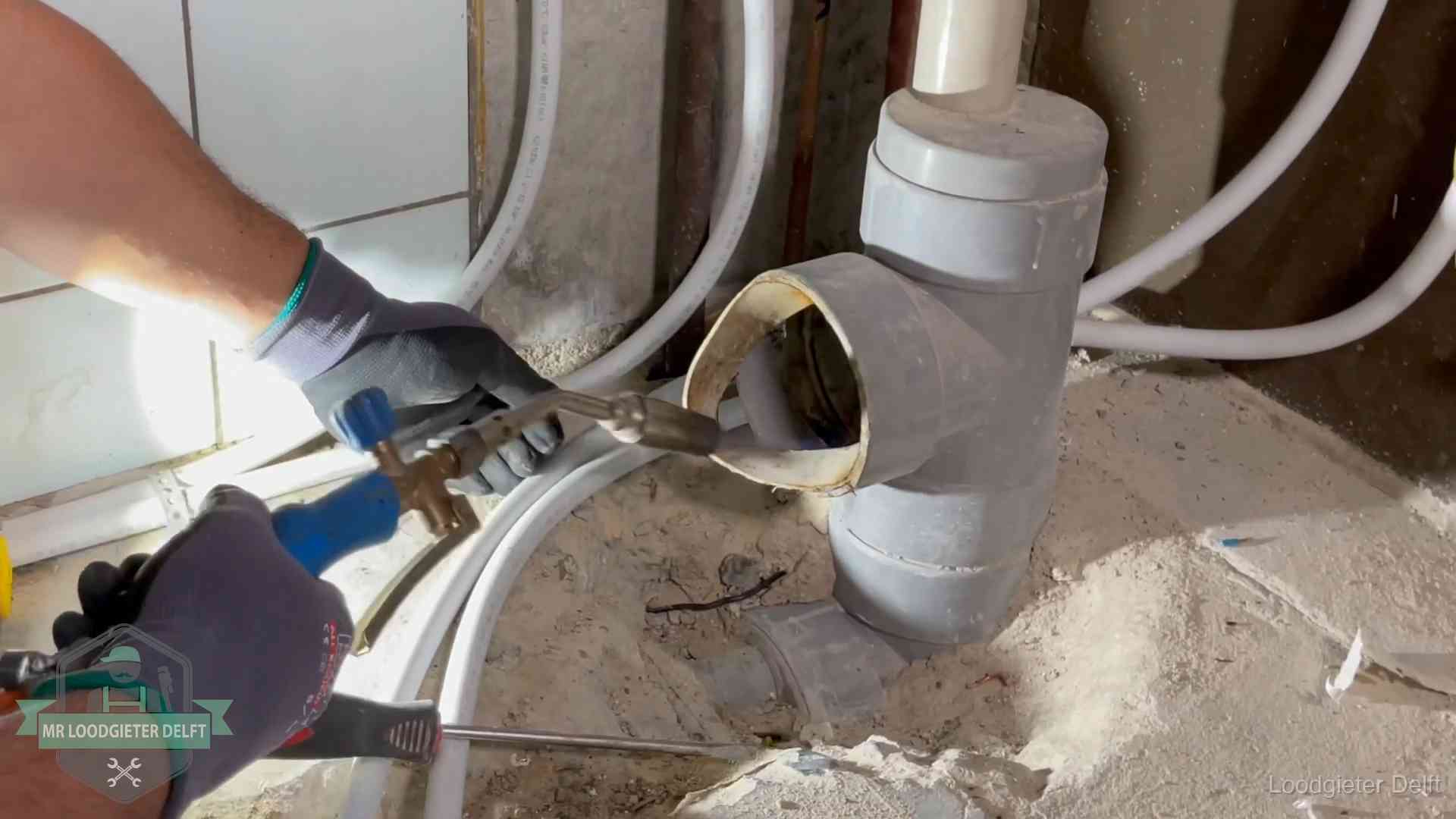 Vakmanschap van onze loodgieters in Delft Loodgieter werkt met brander en messing kraanwerk aan leidingen in Delft