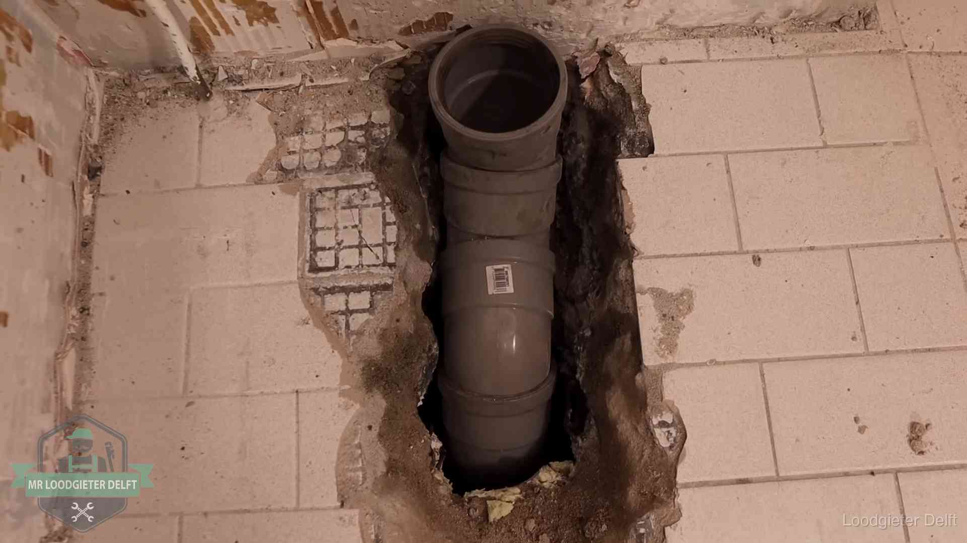 Nieuwe rioolleiding in een opengehakte vloer van een woning in Delft