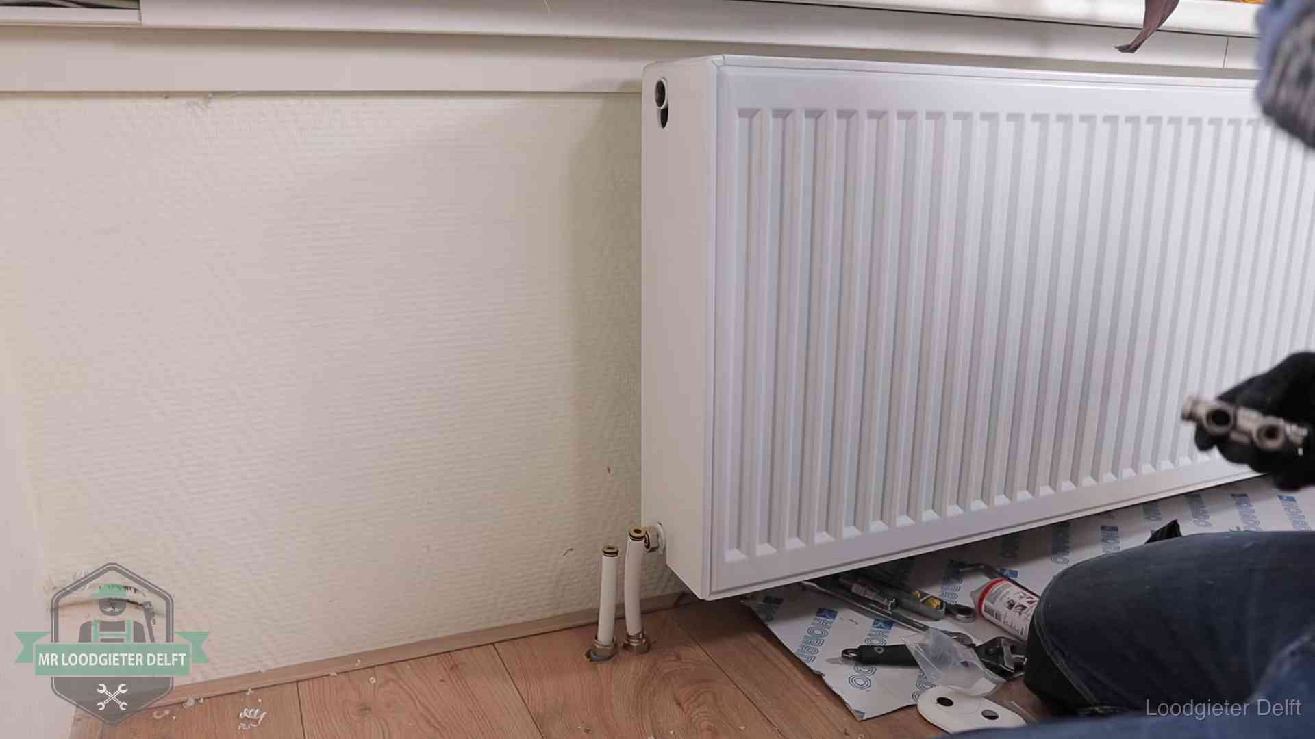 Verwarming per wijk in Delft Nieuw gemonteerde radiator in een woonkamer in Delft
